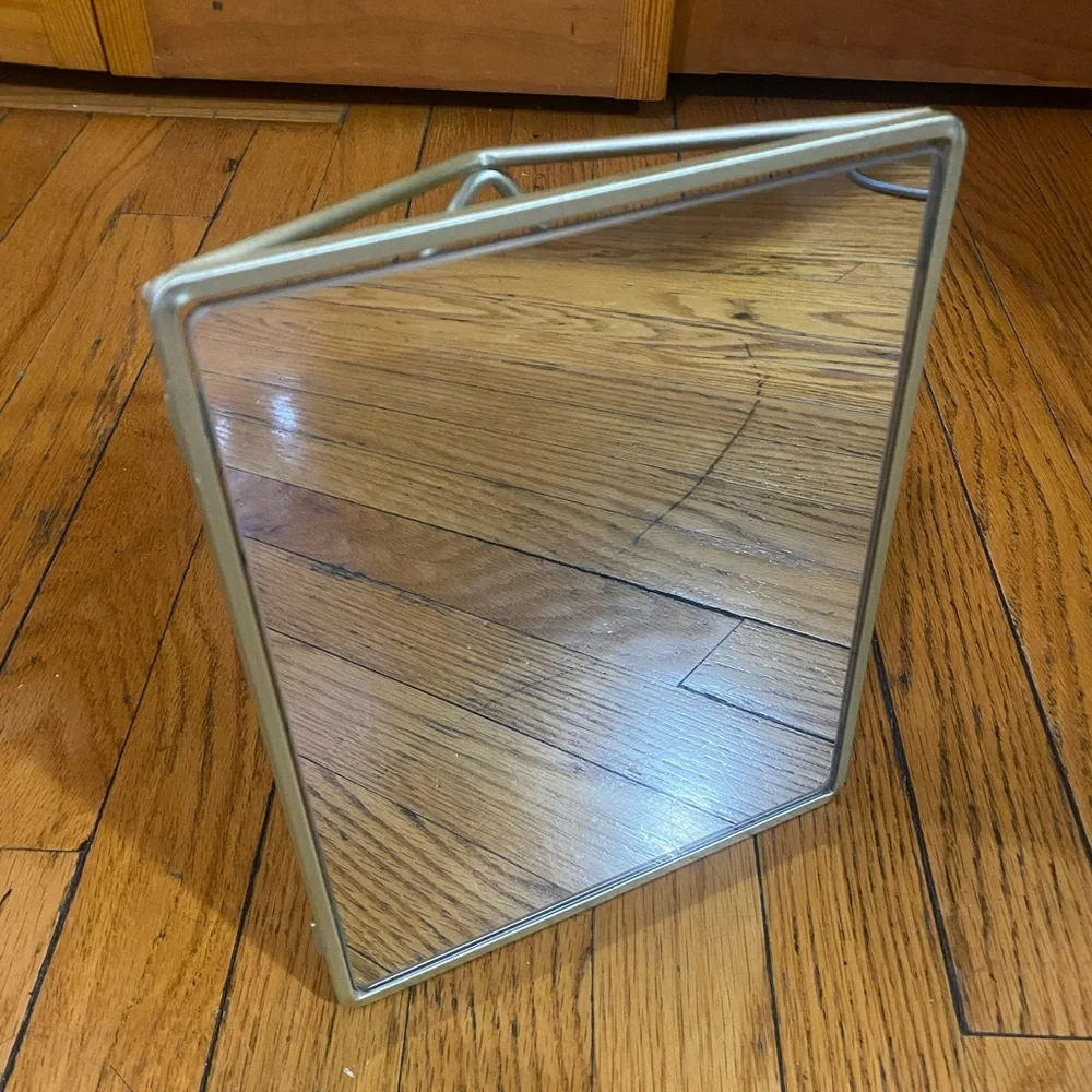 Mirror with geometric metalwork